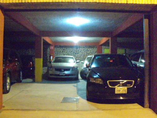 a garage with two cars parked in it at Hotel Mirador Real in Bernal