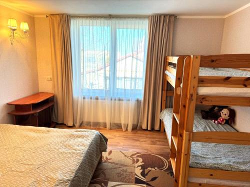 a bedroom with two bunk beds and a doll on the bed at HubaBuba in Ventspils