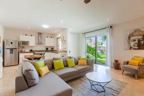 a living room with a couch and a table at Via Tendenza Condos in Playa del Carmen