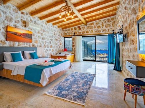 a bedroom with a large bed in a stone wall at Villa NazlıSu in Kaş