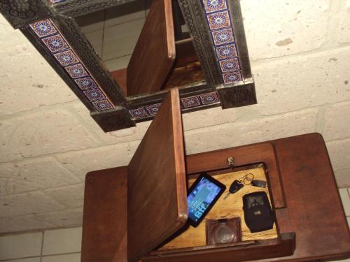 a mirror above a wooden altar with a computer on it at Hotel Mirador Real in Bernal