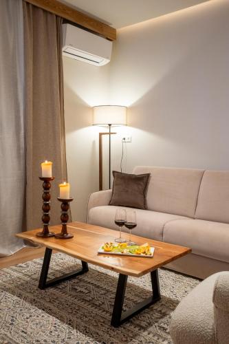a living room with a couch and a coffee table at Likoria Hotel in Arachova