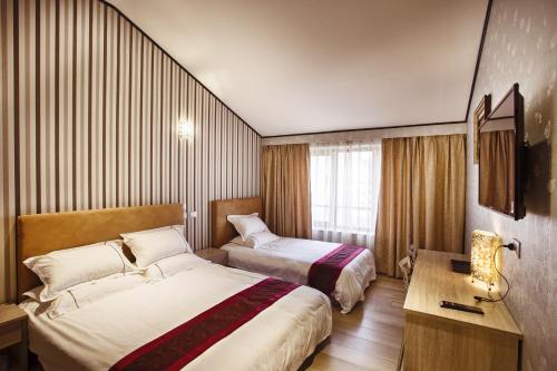 Postel nebo postele na pokoji v ubytování Igiban Hotel