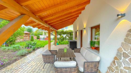 a patio with a wooden table and chairs at Vilux with indoor private parking in Braşov