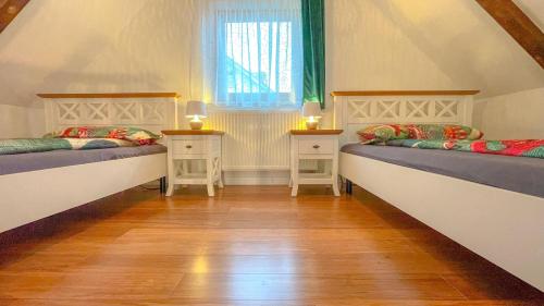 a room with two beds and two night stands at Vilux with indoor private parking in Braşov