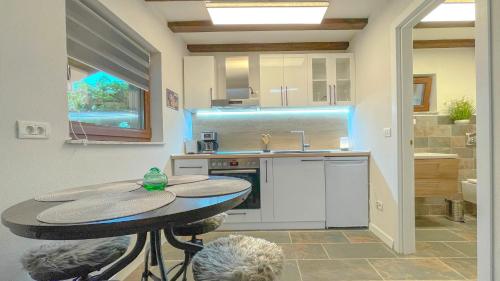 a kitchen with a table and a sink at Vilux with indoor private parking in Braşov