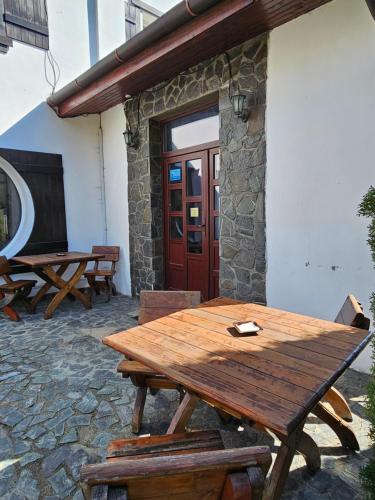 a wooden picnic table in front of a building at Pensiunea Miruna in Moieciu de Jos