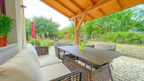 a patio with a table and chairs on a patio at Vilux with indoor private parking in Braşov