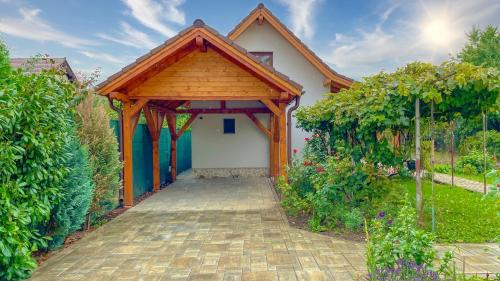 a house with a wooden roof and a walkway at Vilux with indoor private parking in Braşov