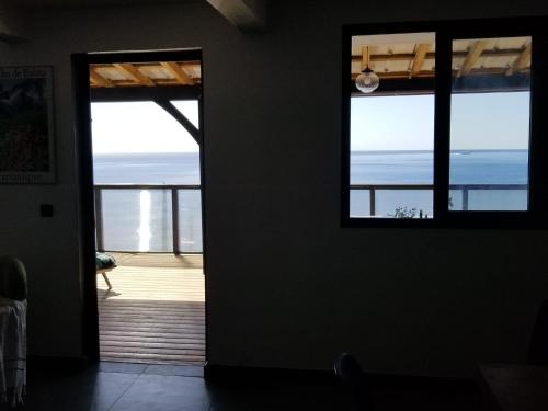 an open door to a room with a view of the ocean at Villa T4 avec piscine, 6 à 8 personnes in Schœlcher
