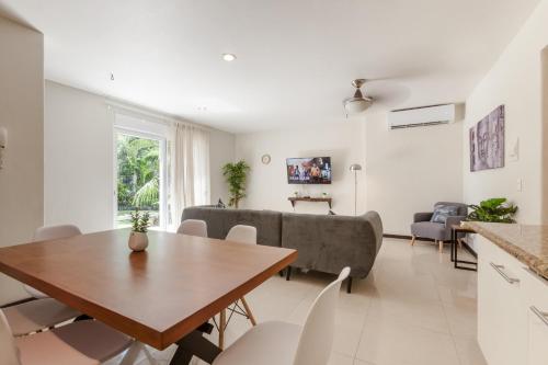 a living room with a table and a couch at Via Tendenza Condos in Playa del Carmen