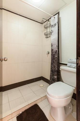 a bathroom with a toilet and a shower at Via Tendenza Condos in Playa del Carmen