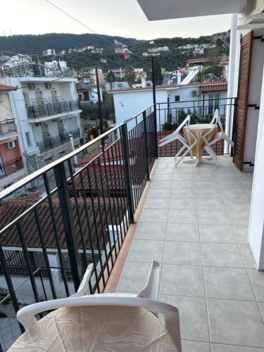 a balcony with a table and chairs on a building at Pansion Angela in Skiathos Town