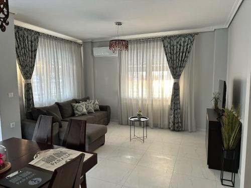 a living room with a couch and a table at Eden Suite Paralia in Paralia Katerinis