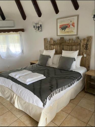 a bedroom with a large bed in a room at Hôtel du Pont Blanc in Saintes-Maries-de-la-Mer