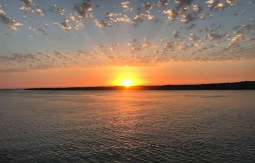 a sunset over a large body of water at Mehdia beach one in Kenitra