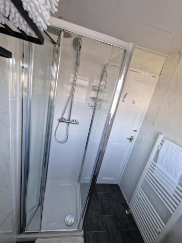 a shower with a glass door in a bathroom at Beck's Sunset Accommodation in Dover
