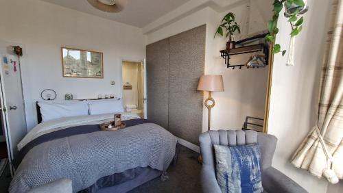 a bedroom with a bed and a chair at The Ocean Guest House in Weymouth