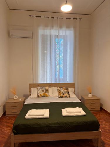 a bedroom with a large bed with a window at La Tela di Elena in Naples