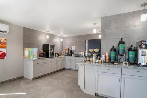 a large kitchen with white cabinets and appliances at Quality Inn Simpsonville-Greenville in Simpsonville