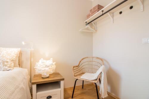 a bedroom with a bed and a chair and a table at Tiigi 8 Cozy Apartment in Tartu