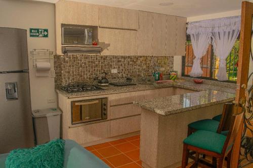 a kitchen with a sink and a stove top oven at Hermosa casa de campo en GUATAPÉ in Guatapé