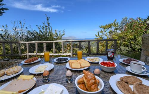 a table with food and bread and eggs on it at Malathiros Traditional Villas in Maláthiros