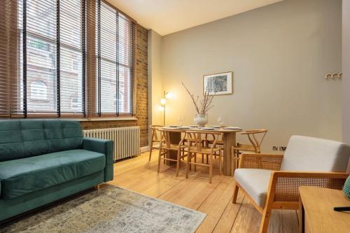 a living room with a green couch and a table at Prime Covent Garden gem with Air-Con in London