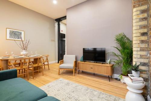 a living room with a television and a dining room at Prime Covent Garden gem with Air-Con in London