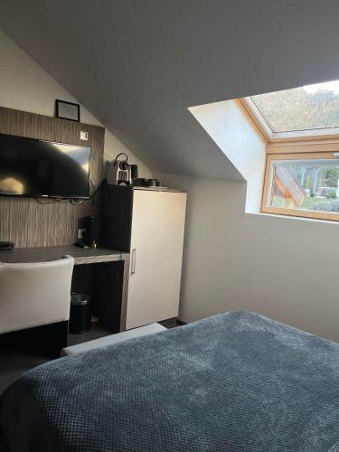 a bedroom with a bed and a skylight at Les Olivades in Gap