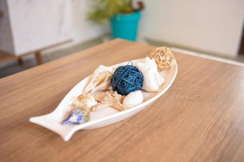 a plate of seashells on a wooden table at The ARC in Scarborough