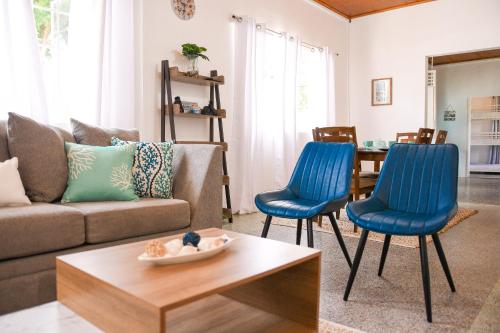 a living room with blue chairs and a couch at The ARC in Scarborough