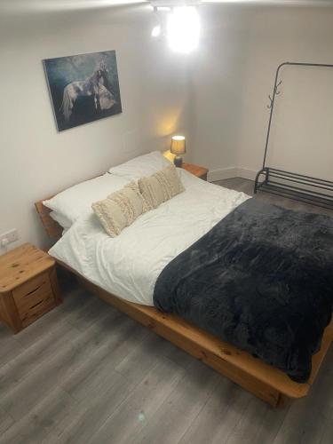 a bedroom with a large bed with white sheets at Lovely Getaway Apartment in Wisbech in Wisbech