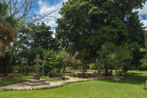 a park with a cross in the grass at Hotel Boutique Casa Xaan in Valladolid
