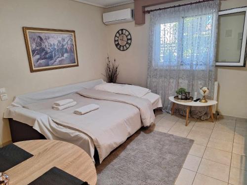 a bedroom with two beds and a table and a window at Apartment near the sea, Volos in Volos