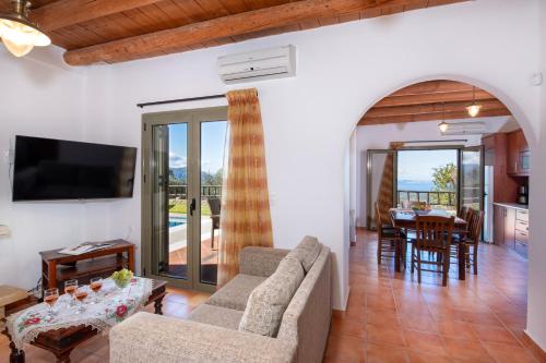 a living room with a couch and a table at Malathiros Traditional Villas in Maláthiros