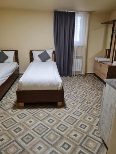 a hotel room with a bed and a floor at Budget Hotel Rooms In Yerevan in Yerevan