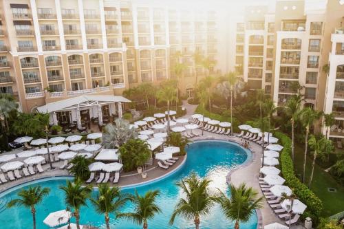 an aerial view of a resort with a pool and chairs at The Ritz-Carlton, Grand Cayman in George Town