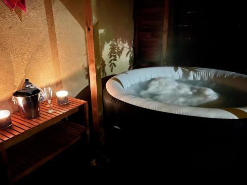 a bath tub filled with lots of foam next to a table at La Glycine in Chamoux-sur-Gelon