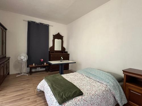 a bedroom with a bed and a table and a mirror at Studio Cosy - Cœur Perpignan in Perpignan