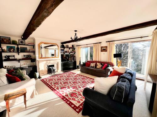 a living room with a couch and a fireplace at Hilltop walkers paradise with a view, sleeps 10 in Fernhurst