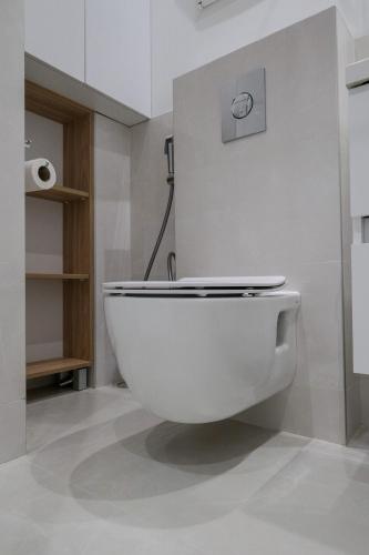 a bathroom with a white toilet in a room at Sanja & Mirza Apartments - Old Town Sarajevo in Sarajevo