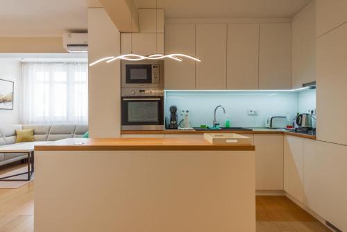 a kitchen with white cabinets and a counter top at Sanja & Mirza Apartments - Old Town Sarajevo in Sarajevo
