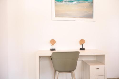 a desk with a chair and a picture on the wall at The ARC in Scarborough