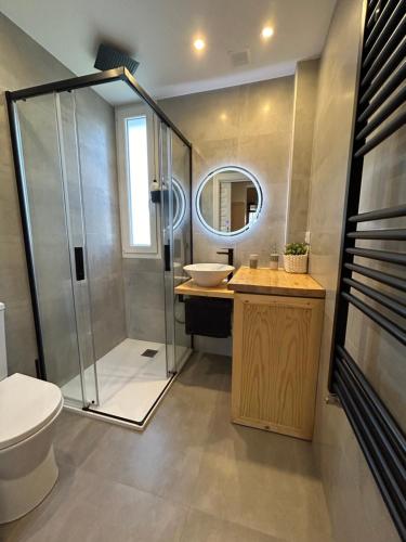 a bathroom with a shower and a toilet and a sink at Paleolítico rural 