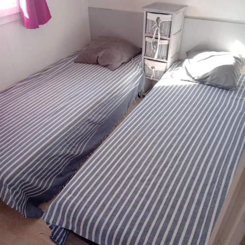 two beds sitting next to each other in a room at Ti case in Le Grau-du-Roi