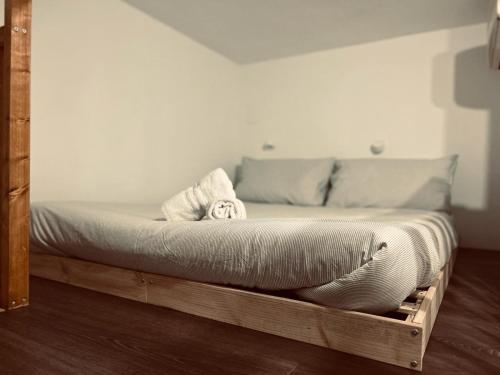 a bed with a wooden frame in a room at Voyager in Cagliari