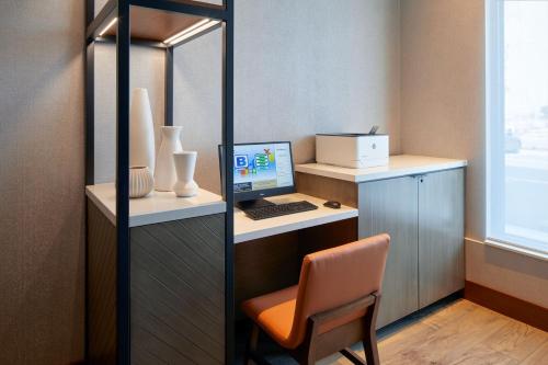 an office with a desk with a computer and a chair at Residence Inn by Marriott San Francisco Airport Millbrae Station in Millbrae
