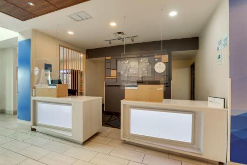 a store with two white counters and boxes at Holiday Inn Express Hotel & Suites Bryan-Montpelier by IHG in Holiday City