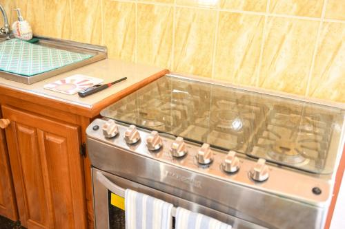 a kitchen with a stove and a counter top at The ARC in Scarborough